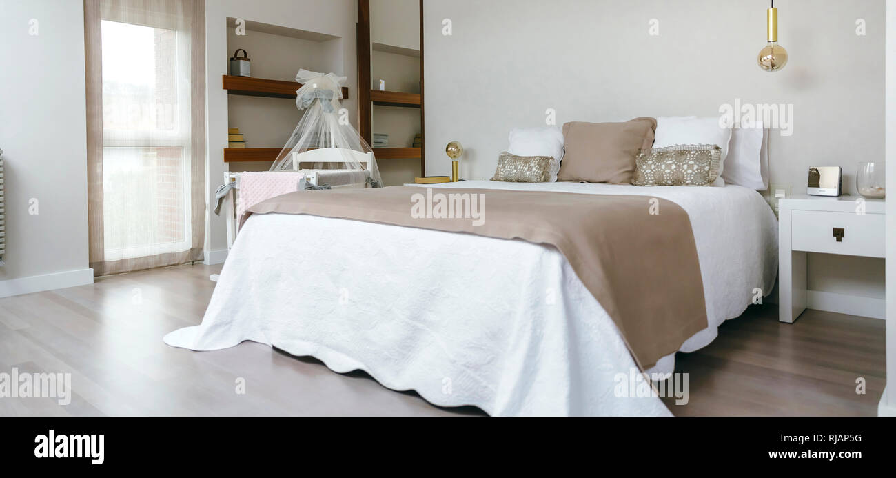 Bedroom with double bed and cot Stock Photo