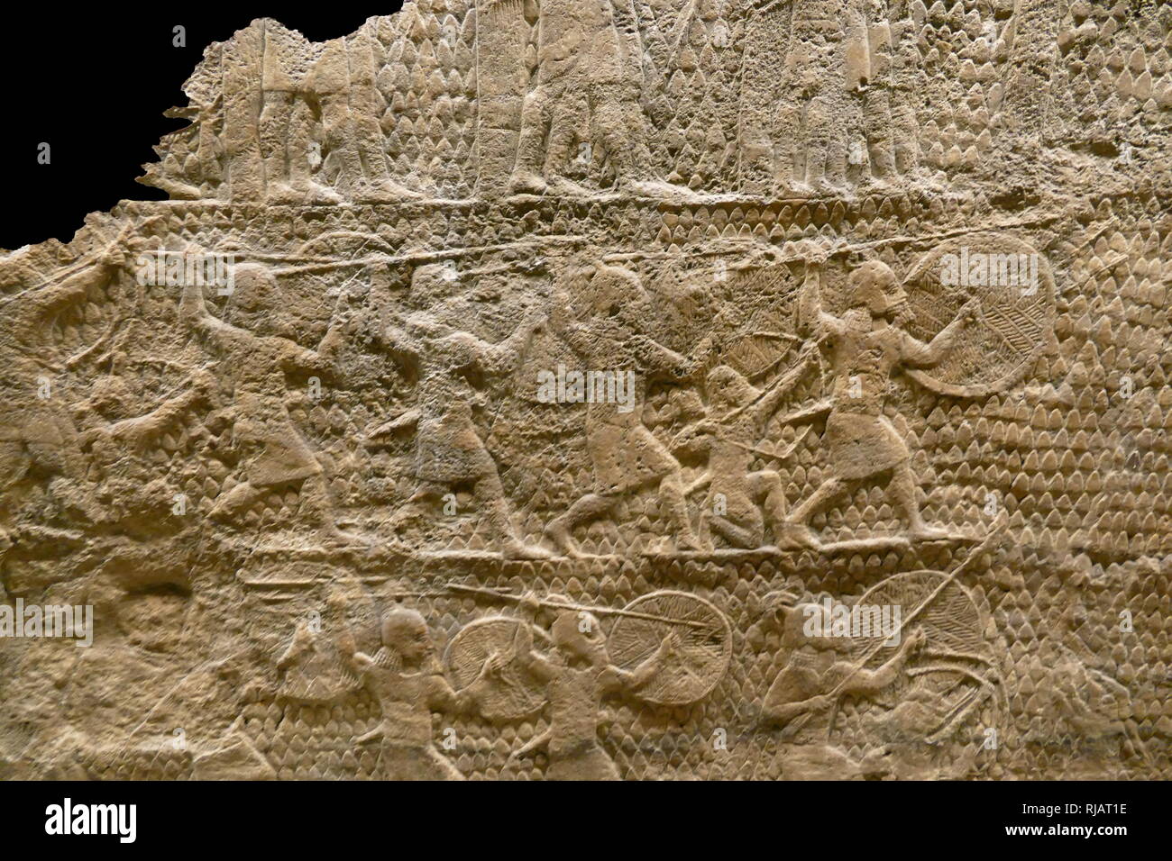 Stone carved relief depicting an attack on Lachish. Assyrian, about 700-692 ВС. From Nineveh, South-West Palace, Room XXXVI, panels 5-6. These panels, show an important incident during Sennacherib's campaign of 701 BC, the capture of Lachish in the kingdom of Judah. artillery hurl stones and archers are shooting arrows, as troops prepare for the assault. Stock Photo