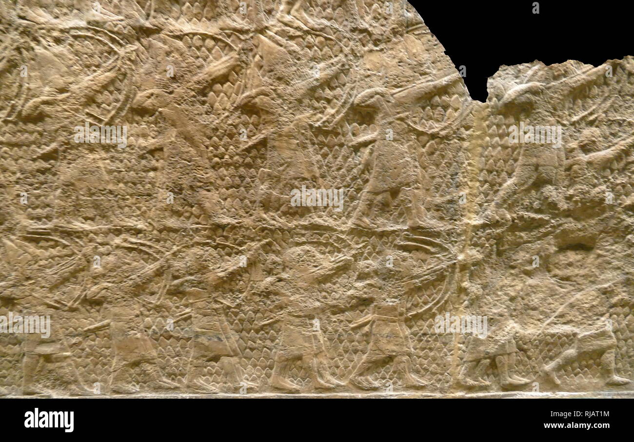 Stone carved relief depicting an attack on Lachish. Assyrian, about 700-692 ВС. From Nineveh, South-West Palace, Room XXXVI, panels 5-6. These panels, show an important incident during Sennacherib's campaign of 701 BC, the capture of Lachish in the kingdom of Judah. artillery hurl stones and archers are shooting arrows, as troops prepare for the assault. Stock Photo