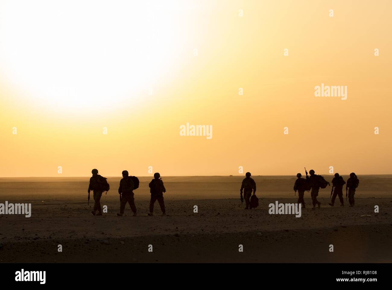 Soldiers with the 77th Armored Regiment, 3rd Brigade, 1st Armored Division, ruck toward their convoy to participate in the squad live-fire exercise Nov. 2, 2016 at Udari Range near Camp Buehring, Kuwait. Infantry Soldiers, indirect fire infantrymen and forward observers synchronized their capabilities during the four-day training event by executing dismounted squad battle drills. Stock Photo