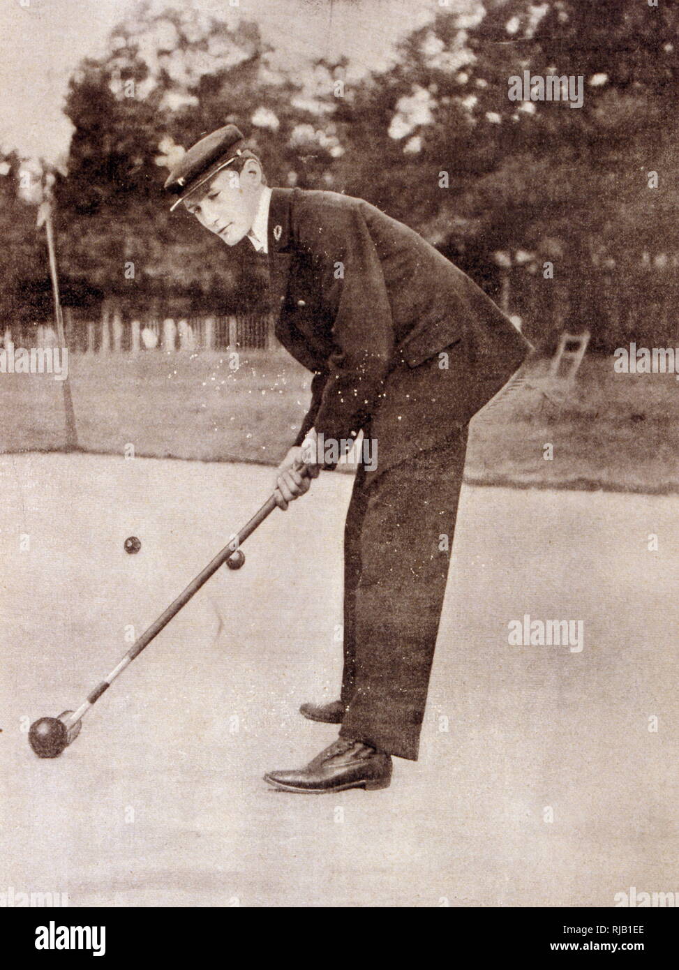 Vintage French photograph of a man playing croquet. 1902 Stock Photo