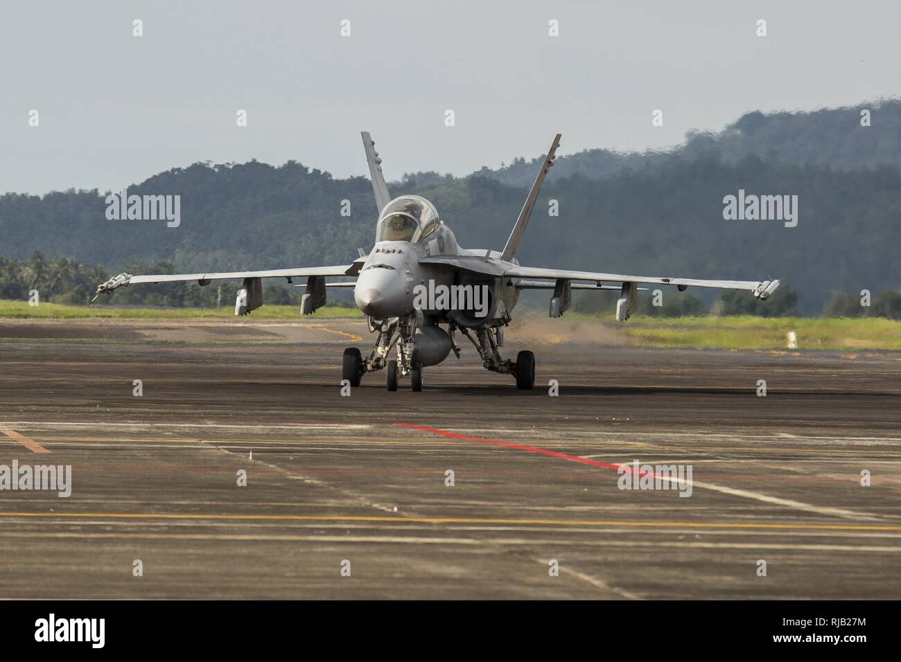 A U.S. Marine Corps F/A-18D Hornet with Marine All-Weather Fighter Attack Squadron (VMFA (AW)) 225, taxis down the flight line during exercise Cope West 17 at Sam Ratulangi International Airport, Indonesia, Nov. 3, 2016. This fighter-focused, bilateral exercise between the U.S. Marine Corps and Indonesian Air Force is designed to enhance the readiness of combined interoperability between the two nations. The combined training offered by this exercise helps prepare the U.S. Marine Corps and Indonesia Air Force to work together in promoting a peaceful Indo-Asia-Pacific region while practicing cl Stock Photo