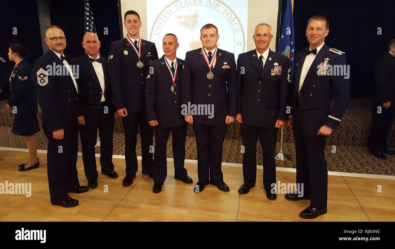 U.S. Airmen with the 139th Airlift Wing pose for a photo during an Airmen Leadership Course graduation ceremony at Offutt Air Force Base, Nebraska, Nov. 4, 2016. From left to right: Command Chief Master Sgt. Randy Miller, Chief Master Sgt. Mark Richie, Senior Airman Daniel Howe, Senior Airman Brian Dolan, Senior Airman Tanner Johnson, Chief Master Sgt. Steven Crenshaw, Lt. Col. James Meyer. Stock Photo