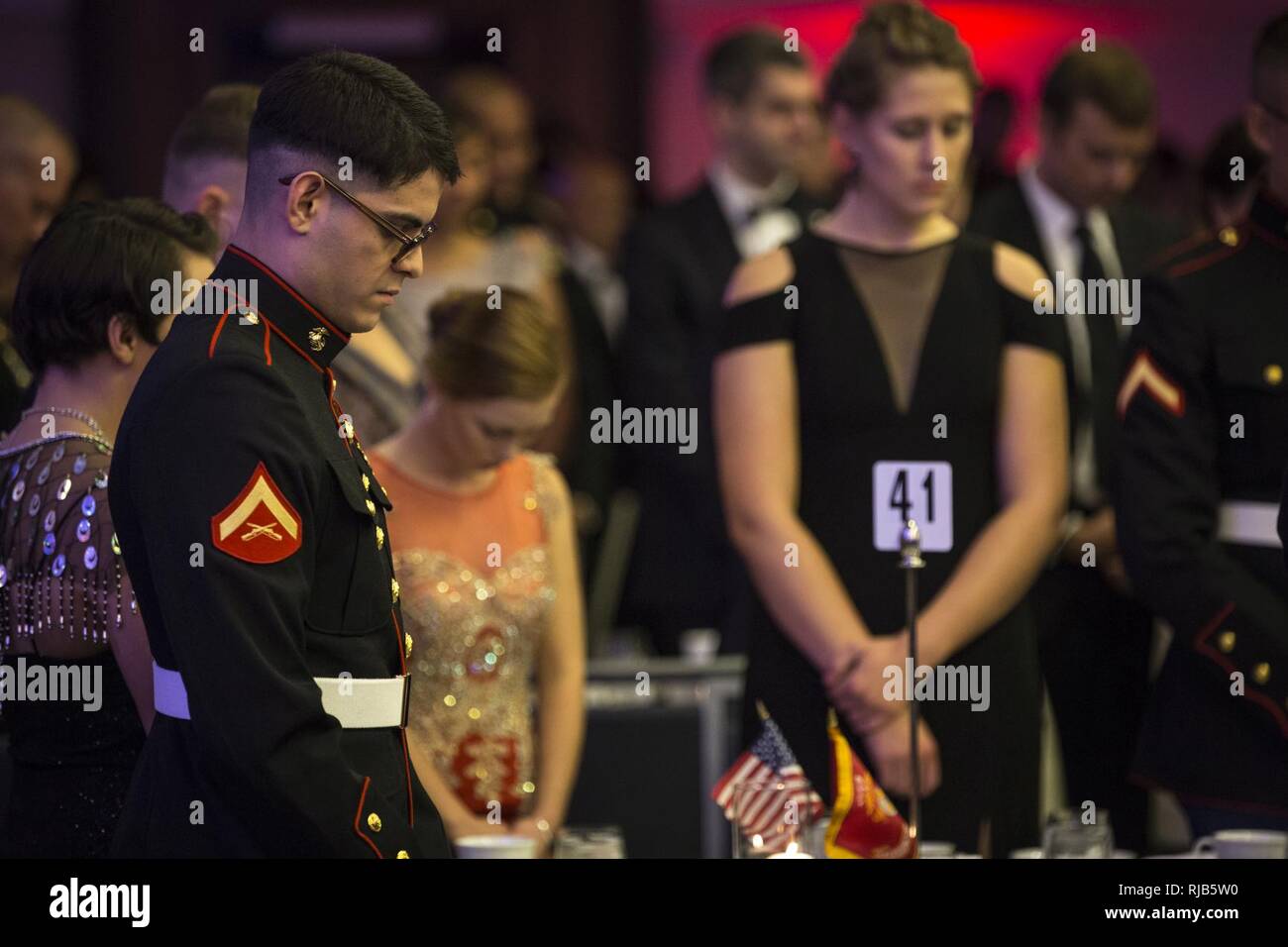 A U.S. Marine bows his head in prayer during the Headquarters & Service Battalion Marine Corps Ball at the Renaissance Arlington Capitol View Hotel, Arlington, Va., Nov. 05, 2016. The ball was held in celebration of the Marine Corps’ 241st birthday. Stock Photo