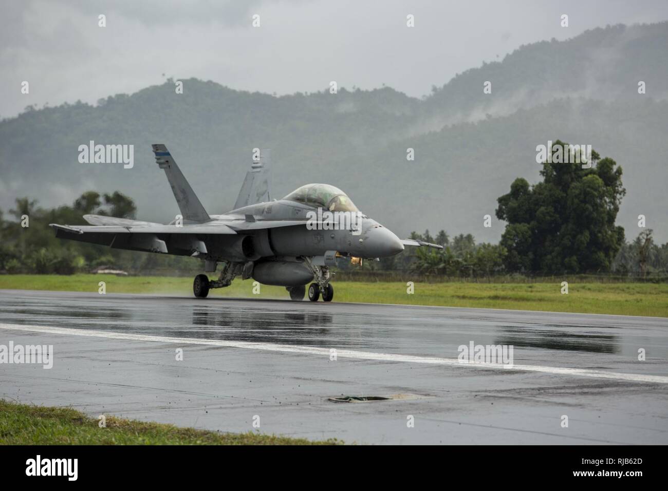A U.S. Marine Corps F/A-18D Hornet with Marine All-Weather Fighter Attack Squadron (VMFA (AW)) 225, taxis down the runway during exercise Cope West 17 at Sam Ratulangi International Airport, Indonesia, Nov. 7, 2016. The combined training offered by this exercise helps prepare the U.S. Marine Corps and Indonesia Air Force to work together in promoting a peaceful Indo-Asia-Pacific region while practicing close air support and air-to-air training that will enhance their to respond to contingencies throughout the region. Both the U.S. F/A-18D Hornets and Indonesian F-16 Fighting Falcons bring uniq Stock Photo