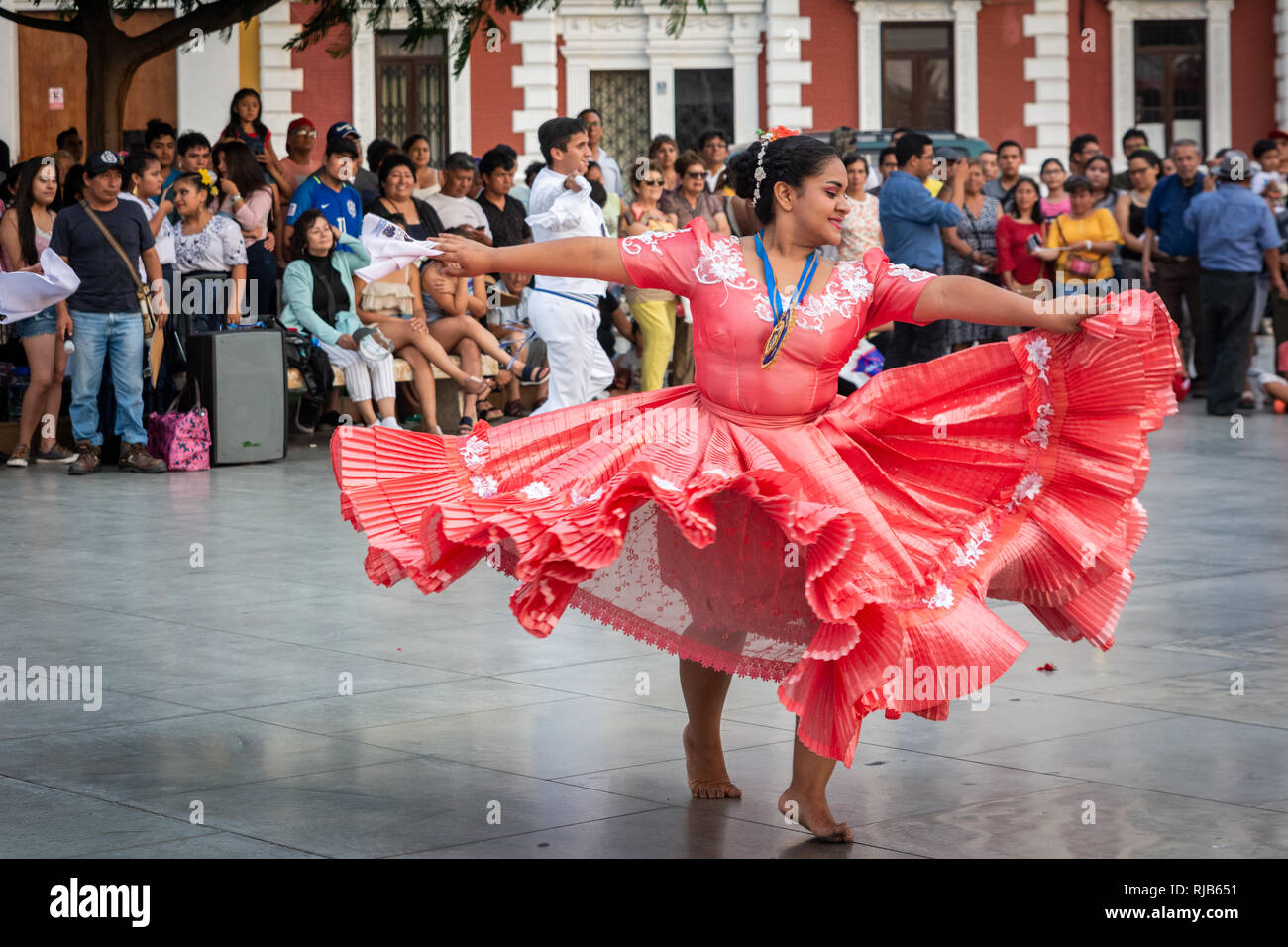 Crowds watching he famous Marinera dance of Trujillo, Peru, in the colonial style main square of the city. Stock Photo