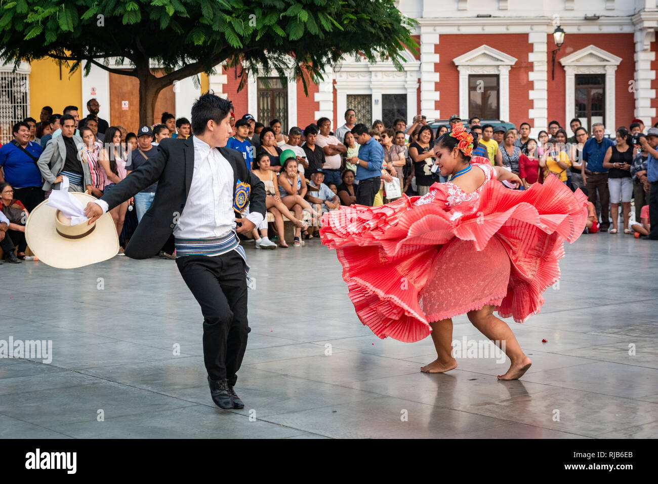 Crowds watching he famous Marinera dance of Trujillo, Peru, in the colonial style main square of the city. Stock Photo