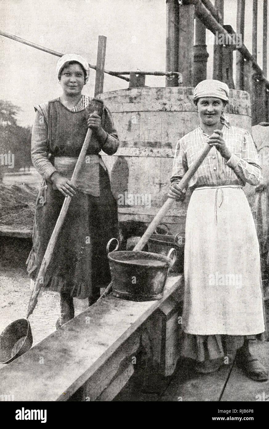Two women doing building work, mixing cement, in a suburb of Vienna, Austria. Stock Photo