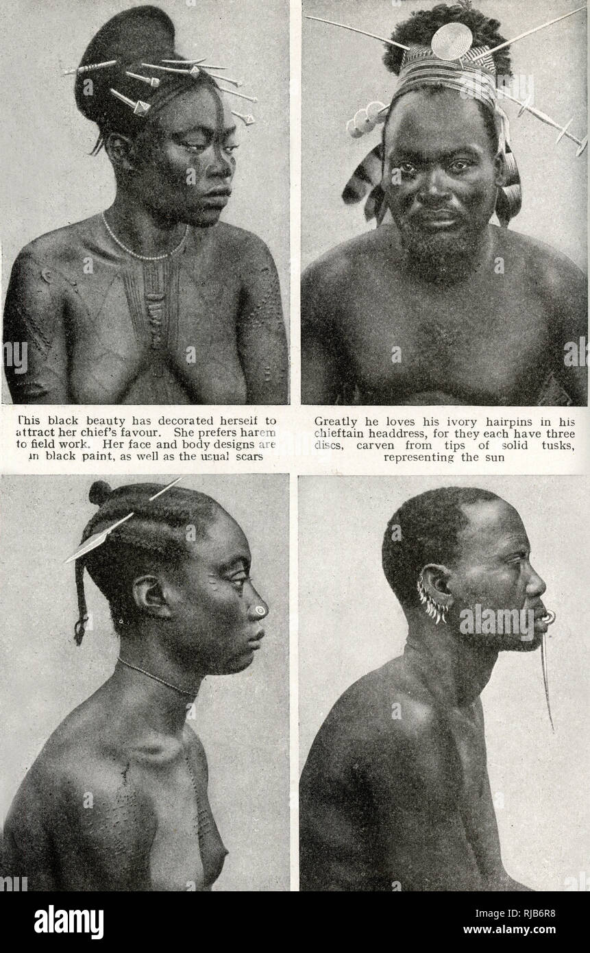 Four people of the Mangbettus (Mangbetu) tribe, Belgian Congo (now Democratic Republic of the Congo), Central Africa.  Showing decorative body scars, ivory hairpins, a nose plug, tooth earrings and a long ivory lip pin. Stock Photo