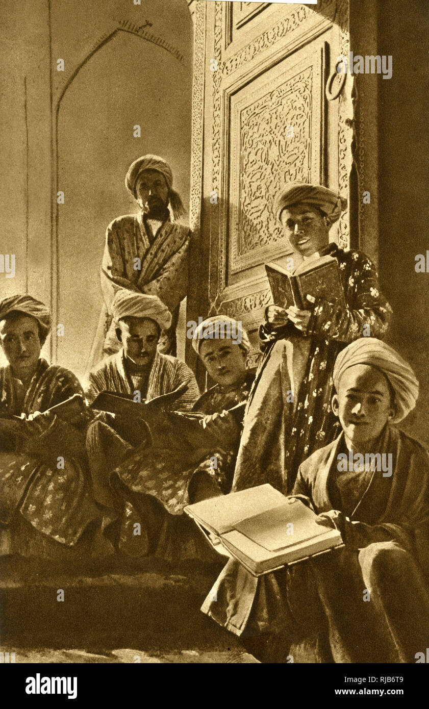 A group of mullahs with their books, wearing patterned vestments in the panelled lecture room of a mosque in Bukhara, Uzbekistan, Central Asia. Stock Photo