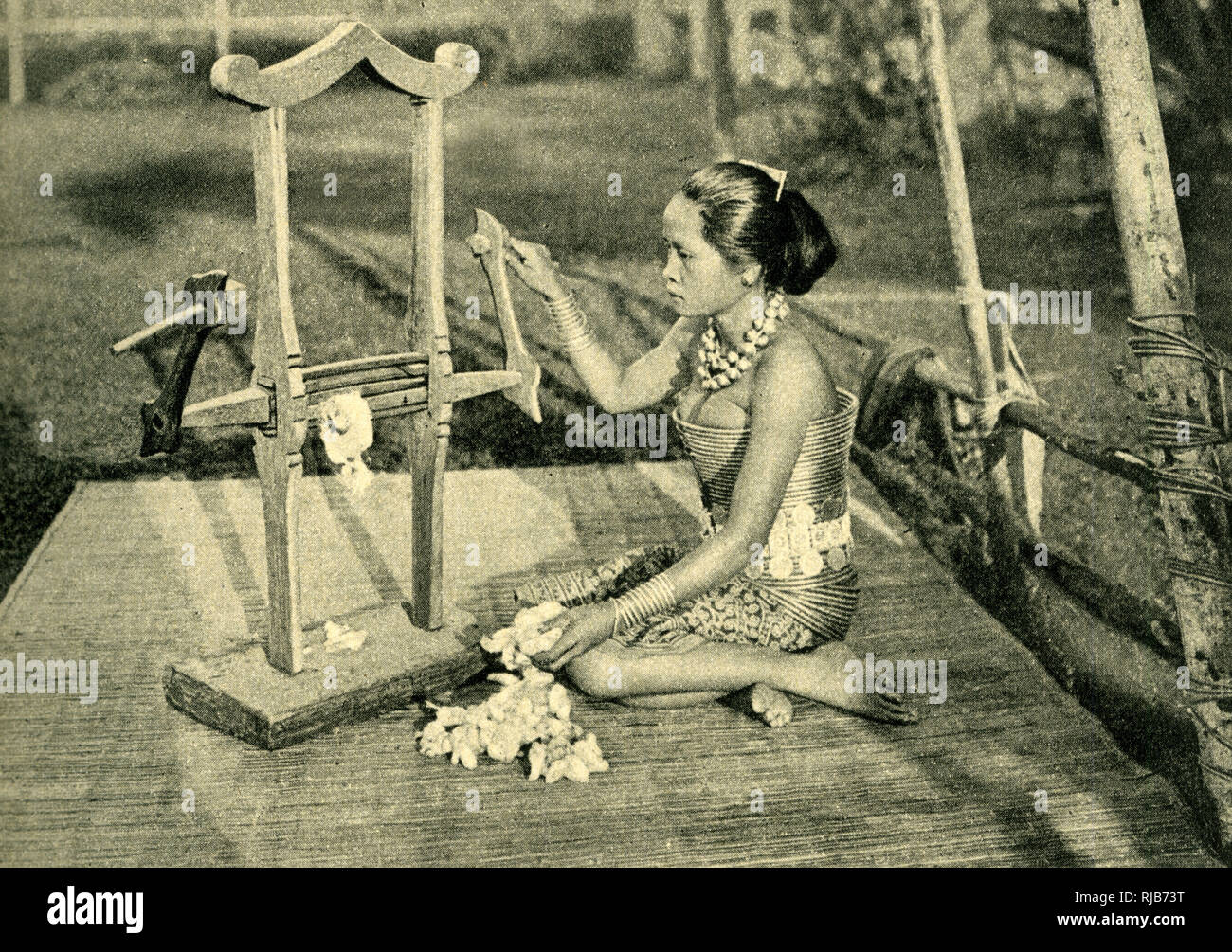 Sea Dayak woman making thread, Borneo, SE Asia Stock Photo