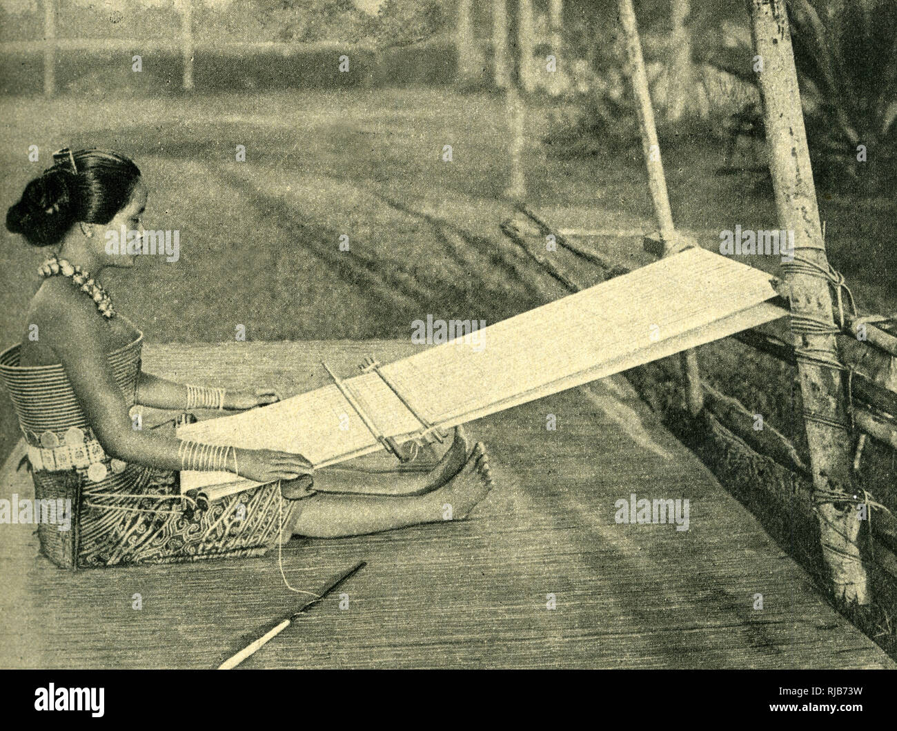 Sea Dayak woman weaving, Borneo, SE Asia Stock Photo