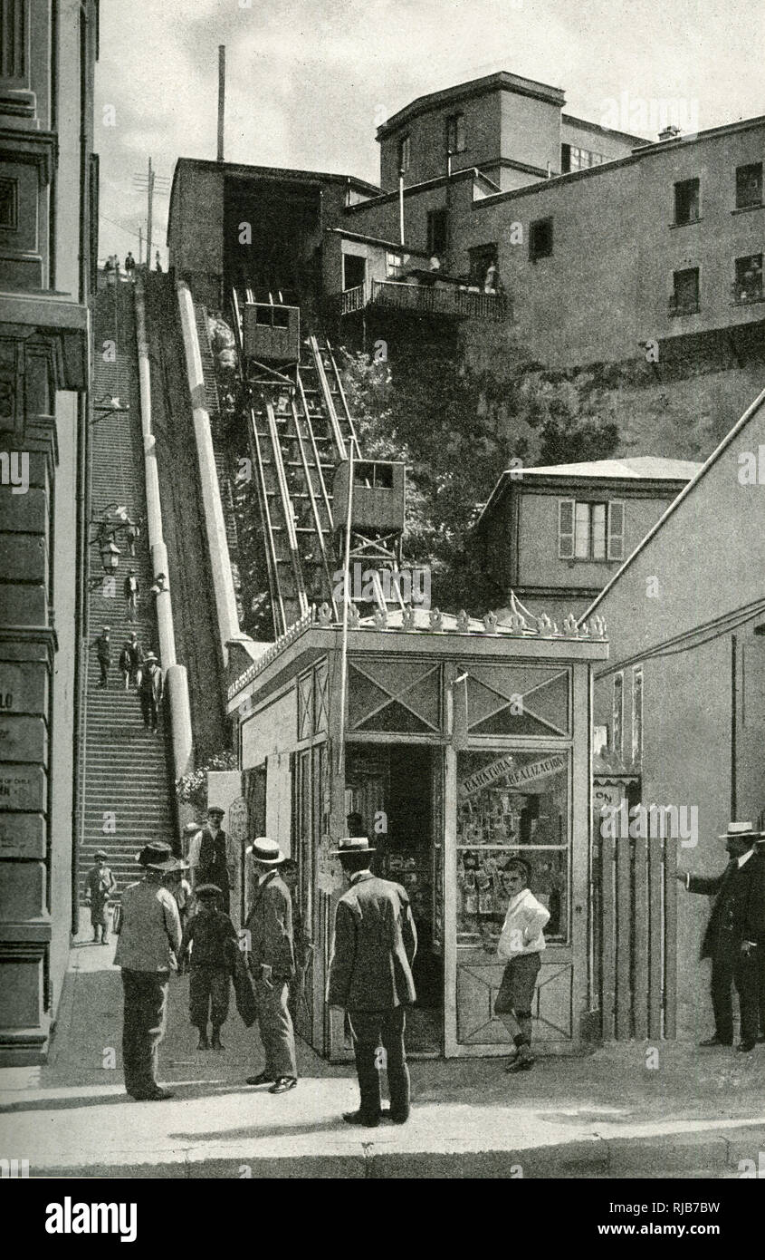 One of many steep funicular railways or elevators in the city of Valparaiso, Chile, South America, with a set of steep steps alongside. Stock Photo