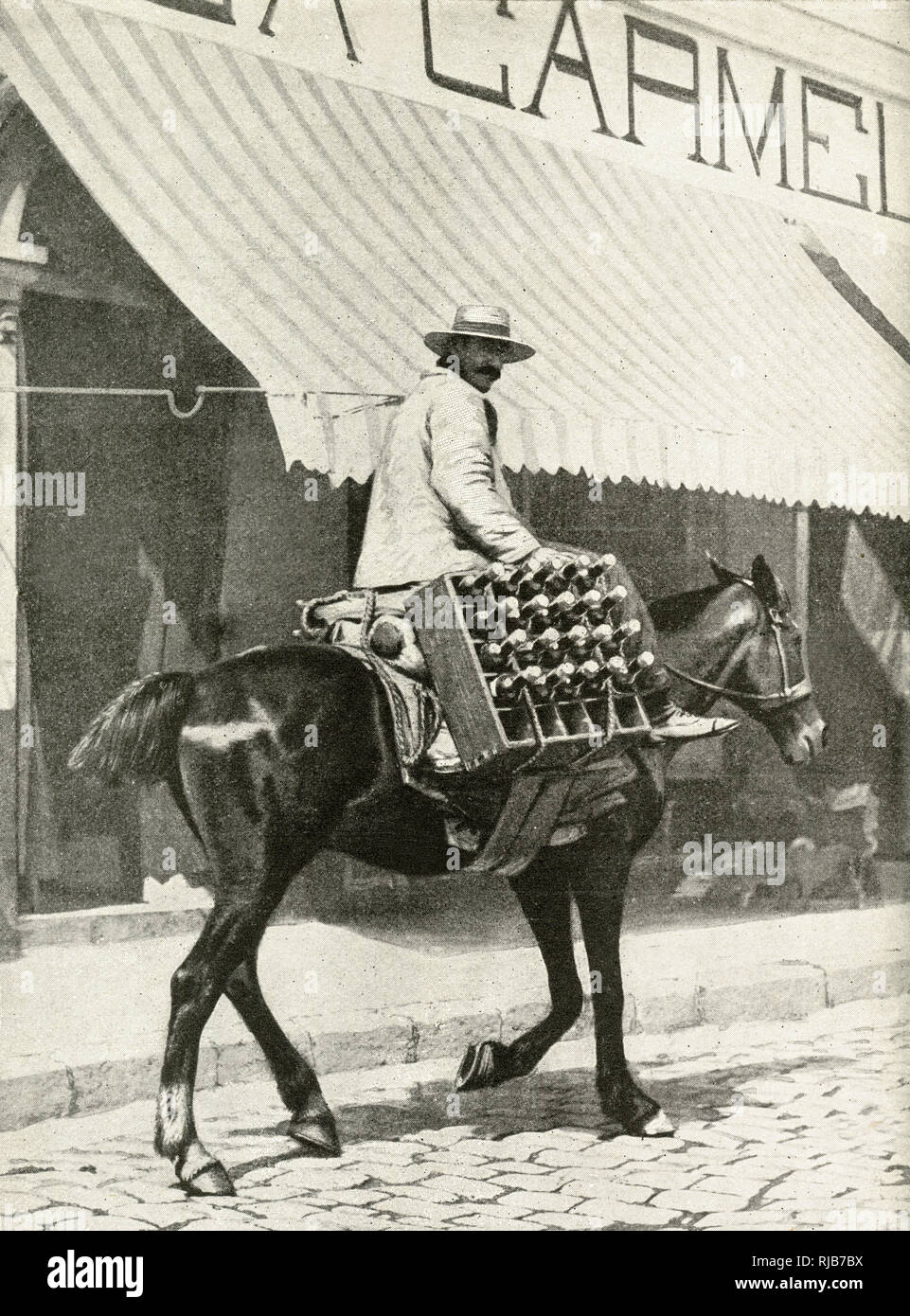 Man on horseback, delivering a crate of beer in the city of Valparaiso, Chile, South America, which is too hilly for wheeled vehicles. Stock Photo