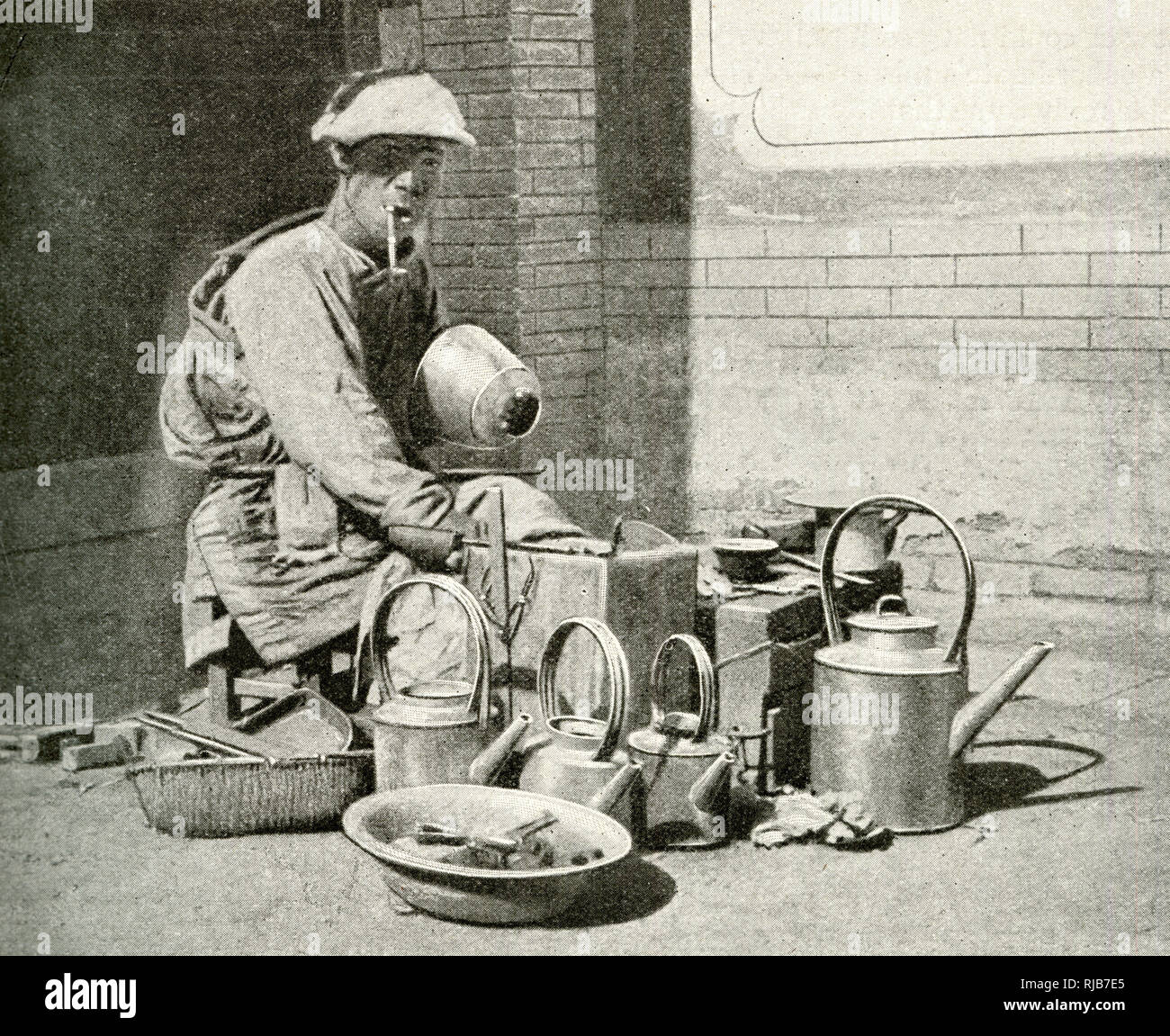 Itinerant tinker in a street with pots, pans and kettles to mend