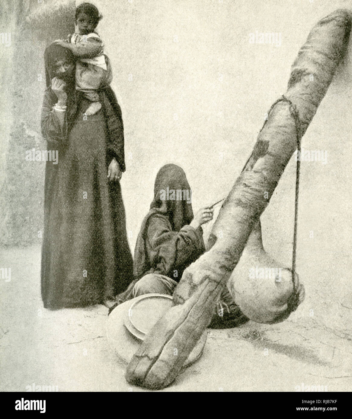 Arab woman with goatskin butter churn, near Cairo, Egypt Stock Photo
