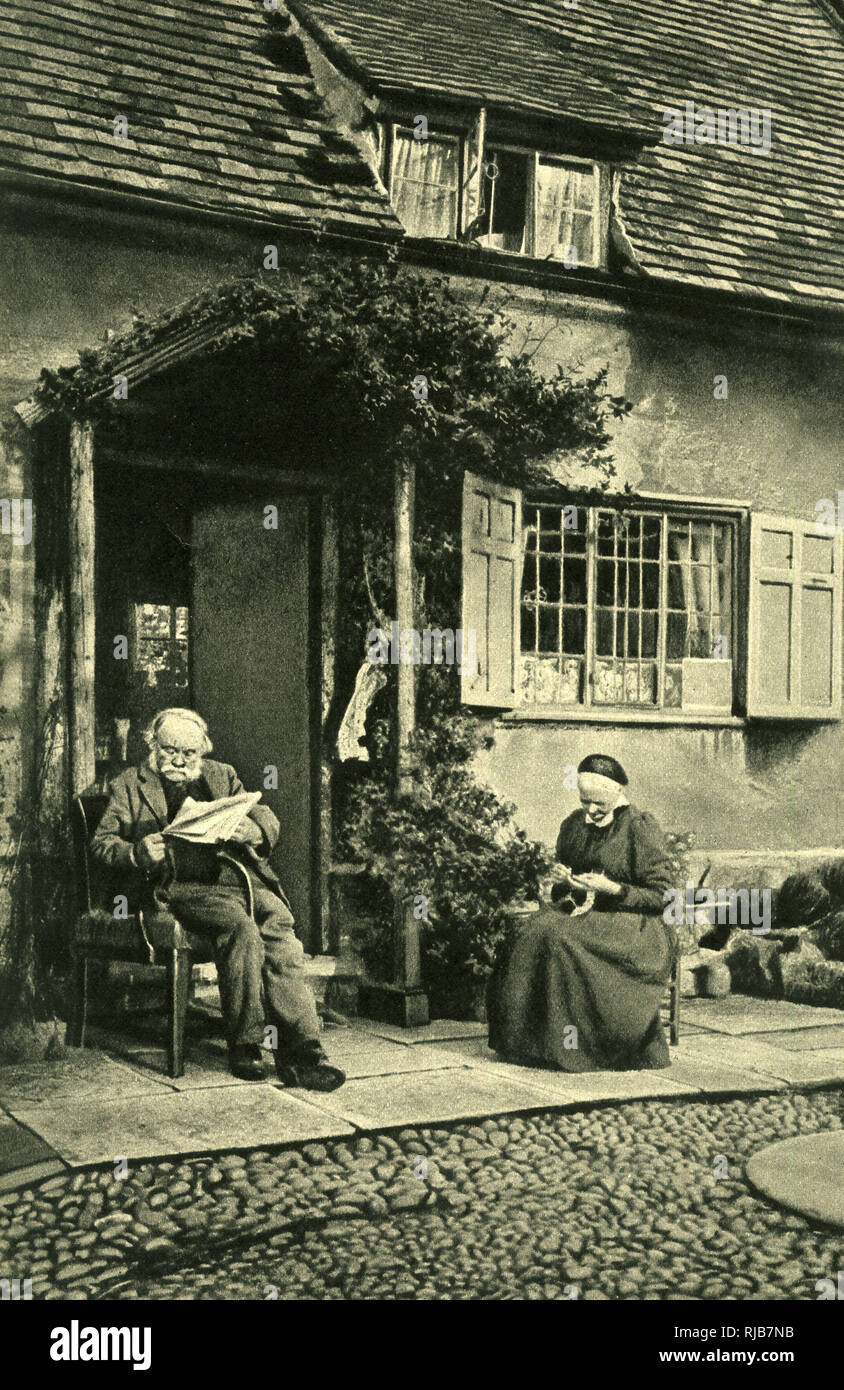 Elderly couple outside cottage, Little Comberton, Worcs Stock Photo