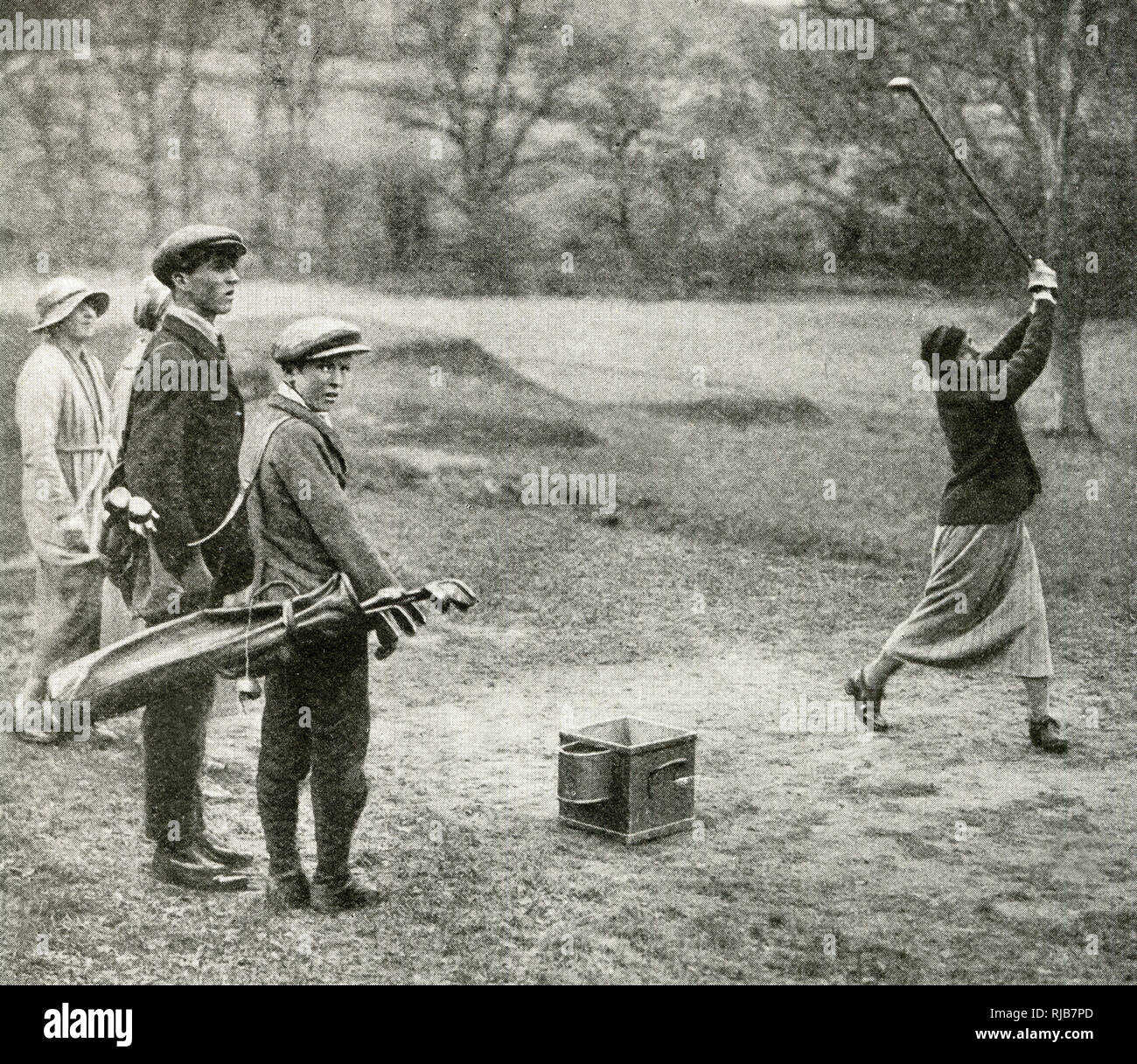 Men and women playing golf at Beaconsfield, Buckinghamshire Stock Photo
