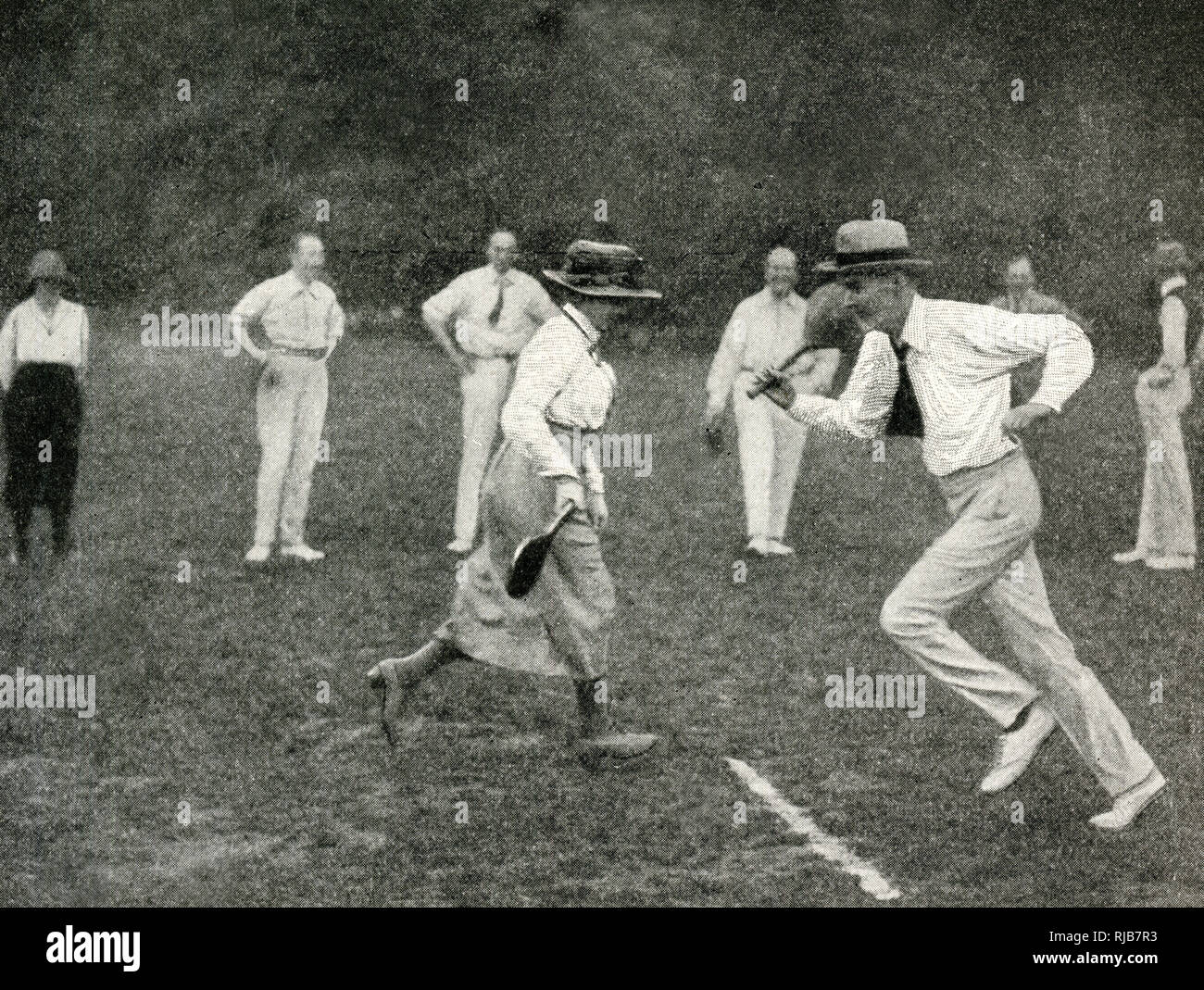 English men and women playing the game of stoolball Stock Photo