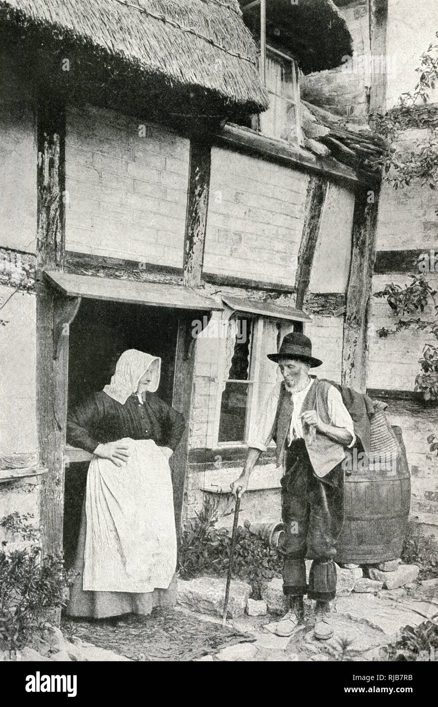 Elderly couple outside cottage, Little Comberton, Worcs Stock Photo