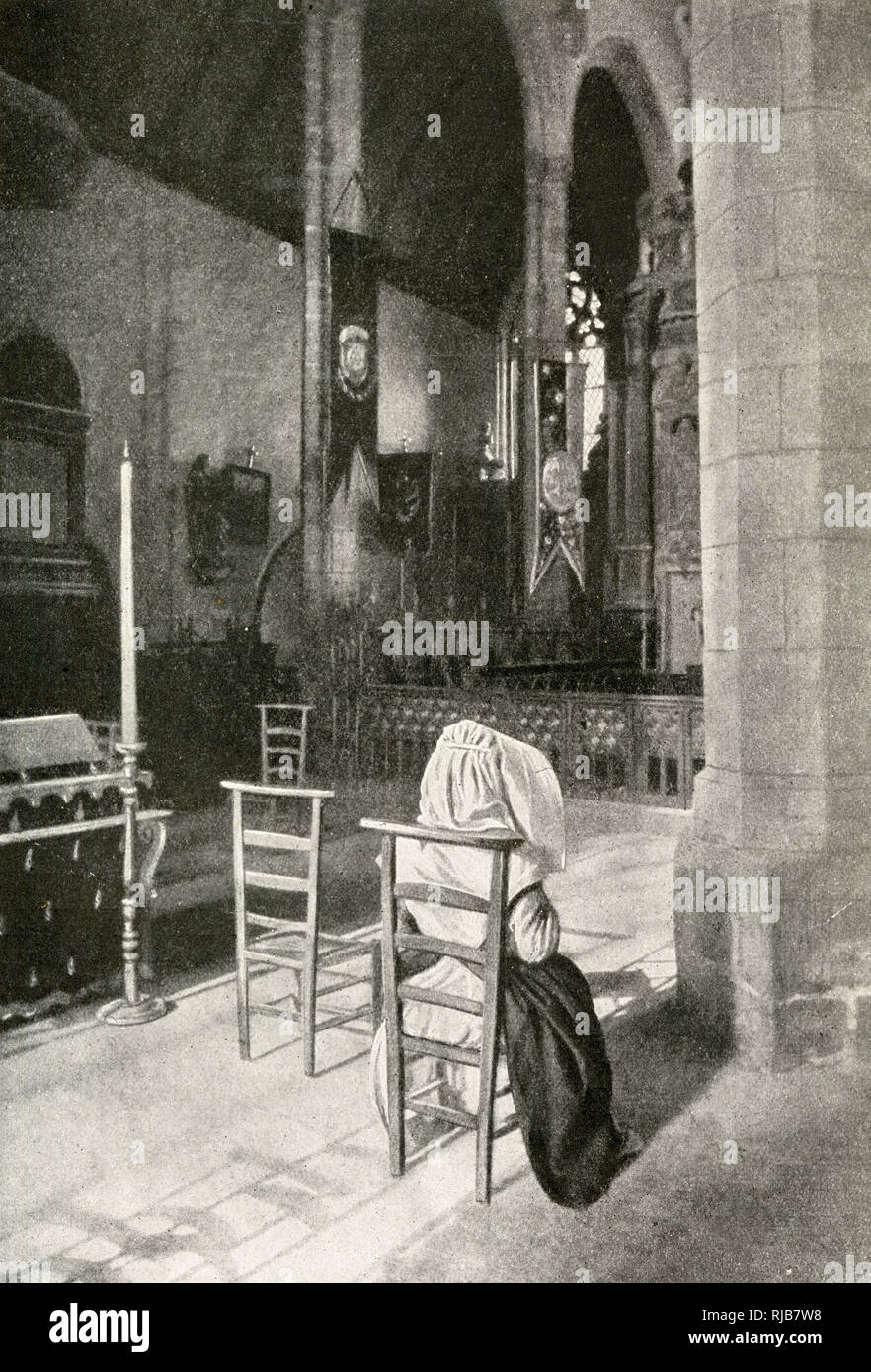 Woman in a Catholic church, Brittany, Northern France Stock Photo