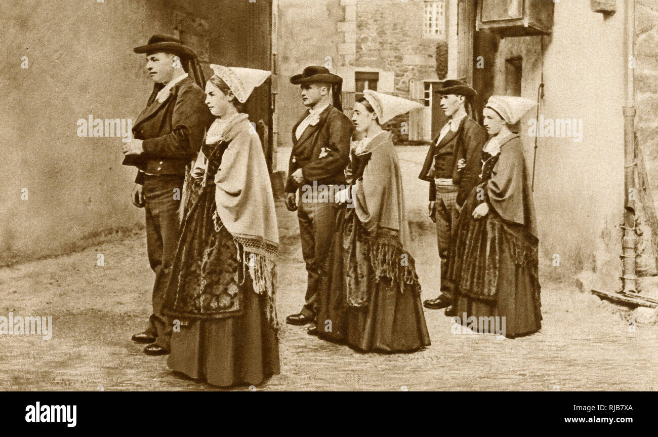 Three young couples out walking in traditional costume at Roscoff