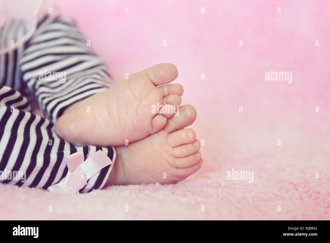 Adorable Little Baby Girl Feet Closeup On Soft Pink Background Stock Photo Alamy