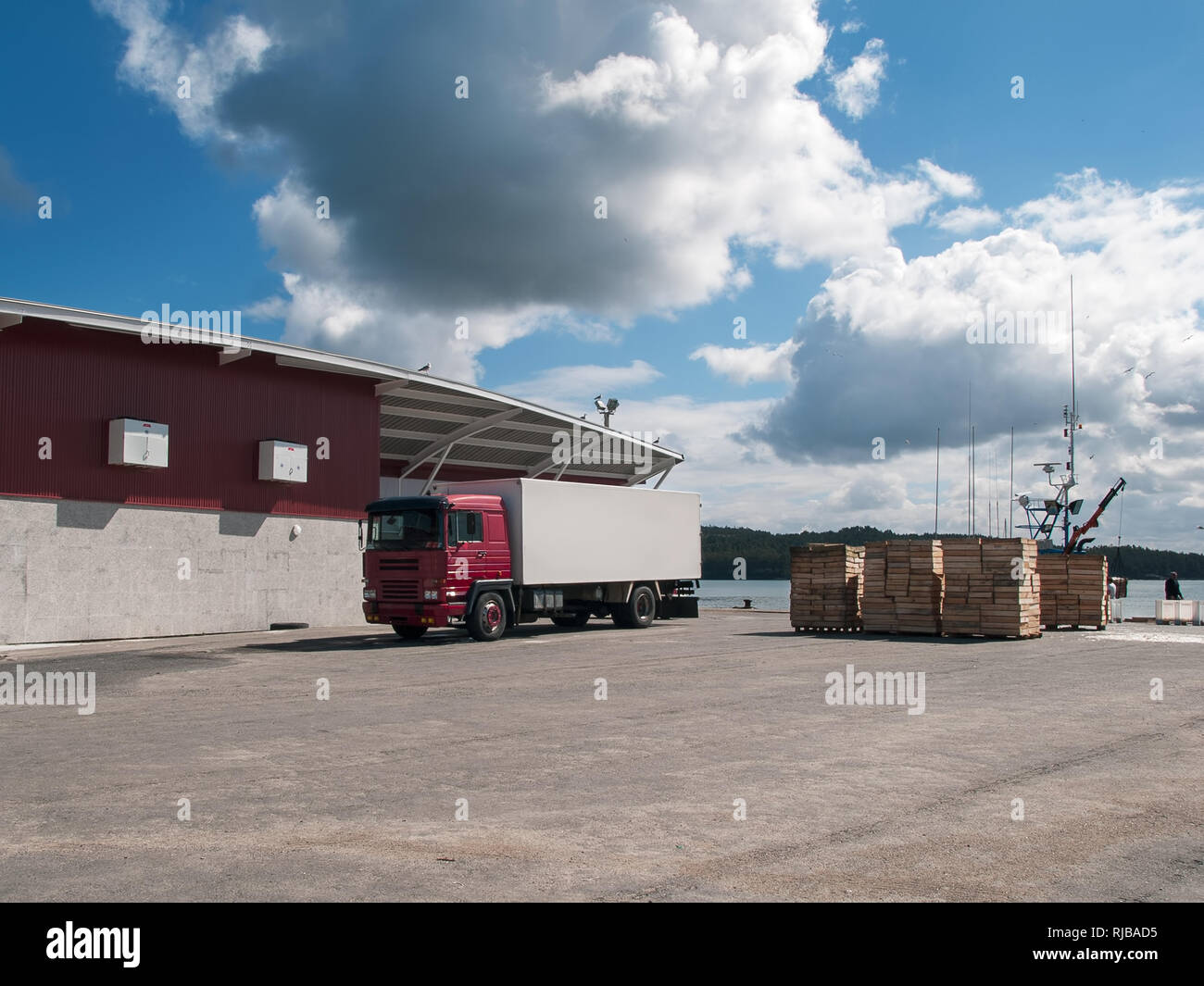 Fishing industry. Fishing port with truck and wooden crates ready to ...