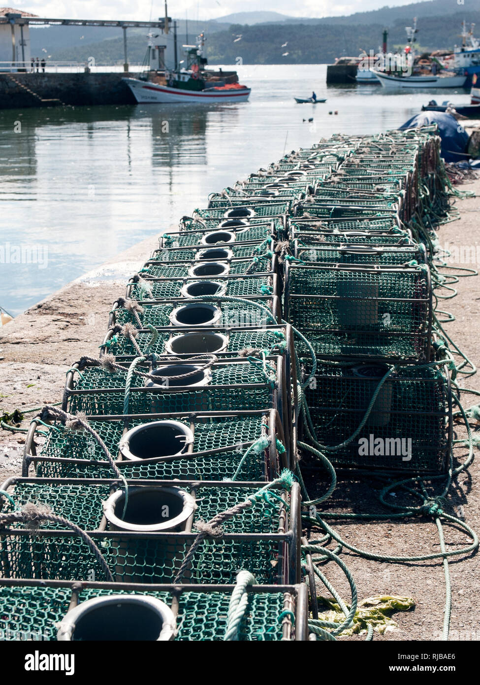 Lobster and crab fishing pot cages creels stacked. Fishing port Stock Photo