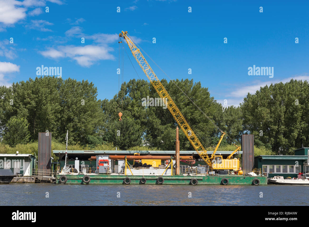 Yelloe crane at the pier in the port of Hamburg Stock Photo