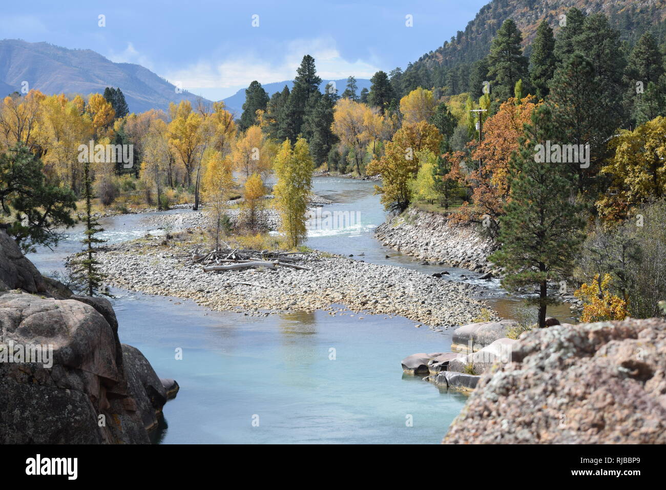 The Animas river snakes through a gorgeous setting just north of Durango, Colorado while leaves show fall colors Stock Photo