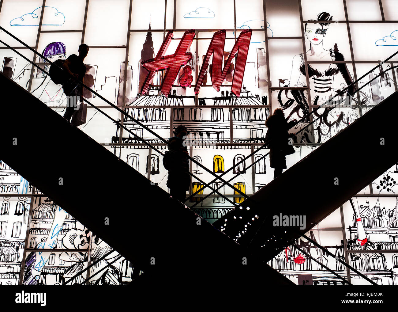 silhouette of people on internal escalators at  H&M Regents street London, Stock Photo