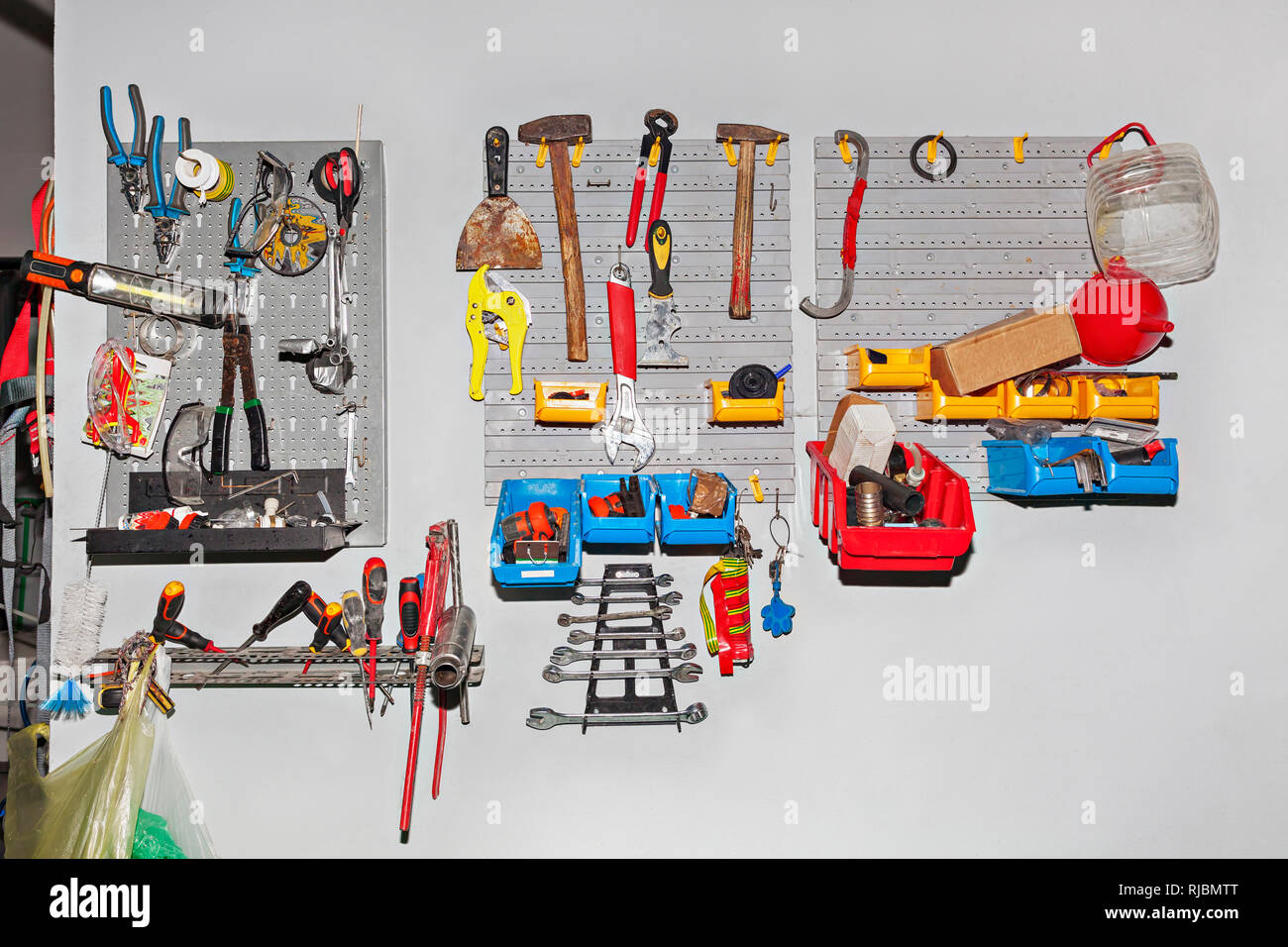 Big assortment of different tools hanging on wall at workshop - Repair concept Stock Photo