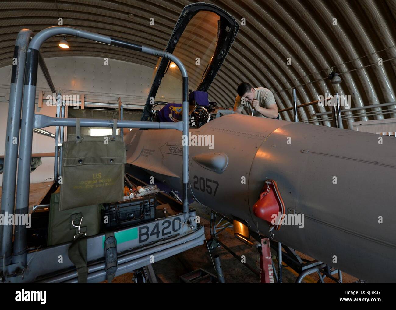 Senior Airman Chase Doering, 31st AMXS avionics systems journeyman, repairs an F-16 Fighting Falcon, Jan. 10, 2018, at Aviano Air Base, Italy. Doering repaired a switch which allows pilots to adjust auto-pilot settings. Stock Photo