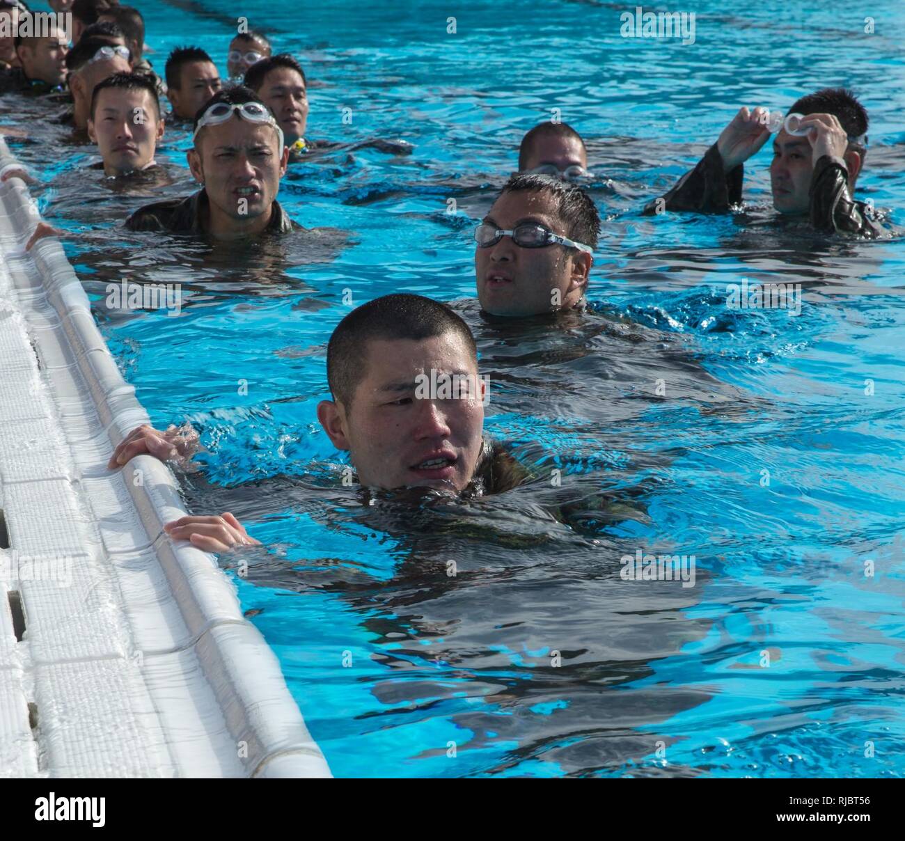 Soldiers in the Japan Ground Self Defense Force conduct Marine Corps intermediate swim qualification as a part of the Exercise Iron Fist on Camp Pendleton, CA, Jan. 16, 2018. Exercise Iron Fist brings together U.S. Marines from the 11th Marine Expeditionary Unit and Soldiers from the Japan Ground Self Defense Force, Western Army Infantry Regiment, to improve bilateral planning, communicating, and conduct combined amphibious operations. Stock Photo