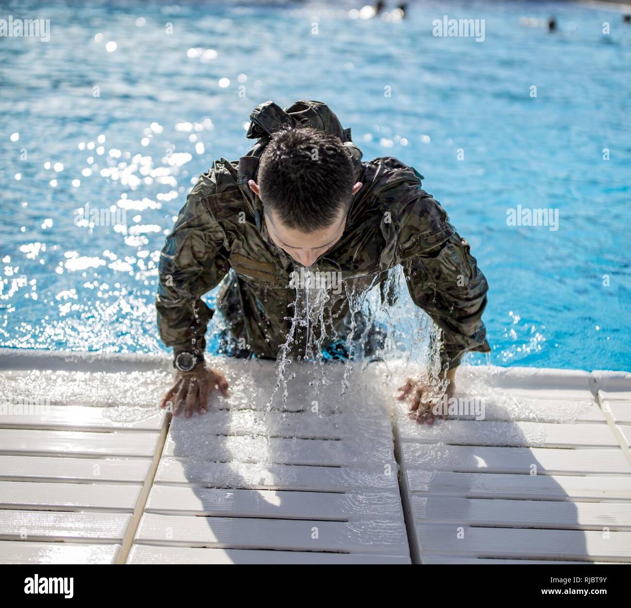 MARINE CORPS BASE CAMP PENDLETON, Calif. – A Japan Ground Self Defense Force soldier leaves a pool during a Marine Corps intermediate swim qualification as part of exercise Iron Fist Jan. 16, 2018. Iron Fist brings together U.S. Marines from the 11th Marine Expeditionary Unit and Soldiers from the Japan Ground Self Defense Force, Western Army Infantry Regiment, to improve bilateral planning, communicating, and conduct combined amphibious operations. Stock Photo