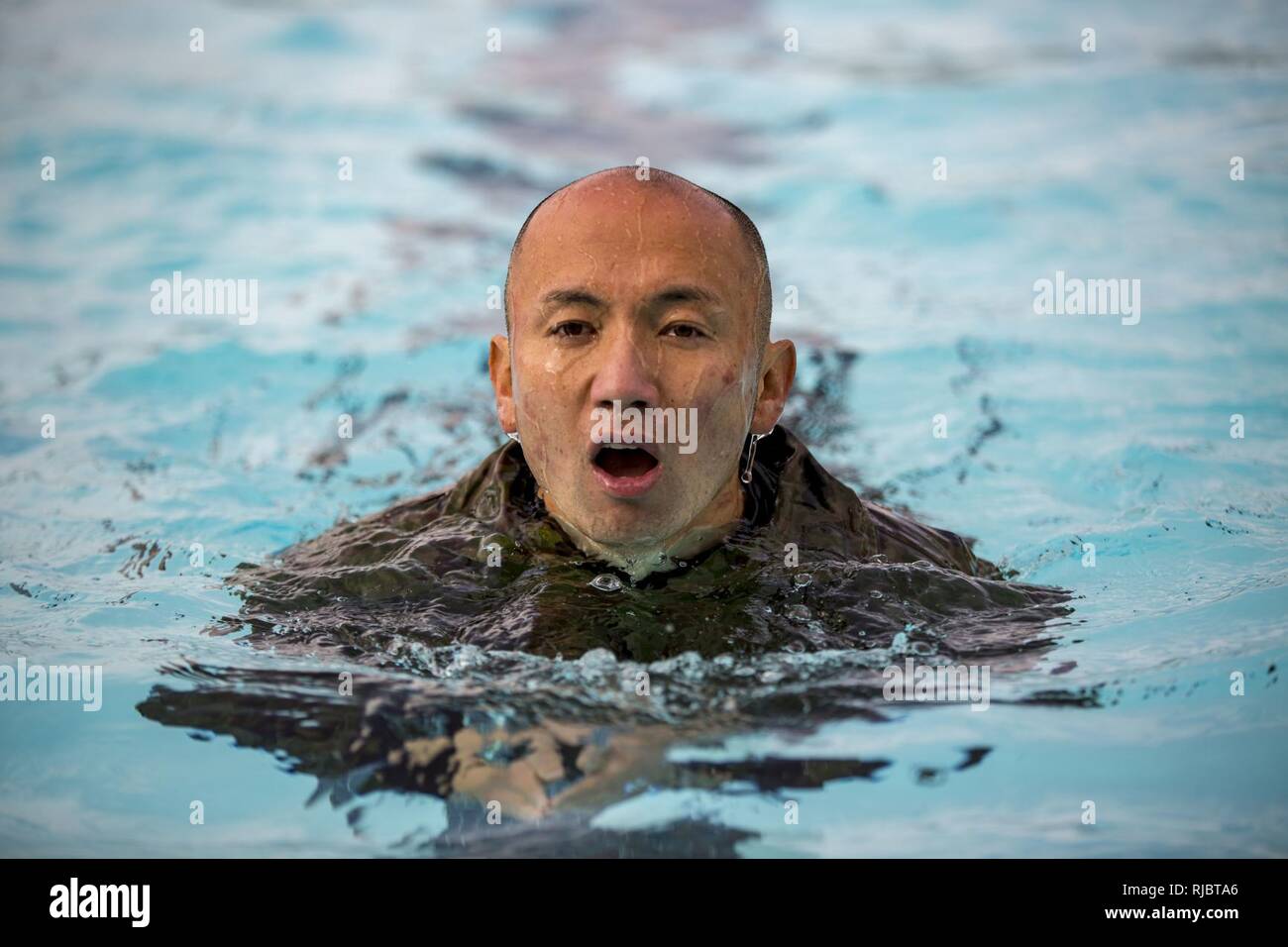 MARINE CORPS BASE CAMP PENDLETON, California – A Japan Ground Self Defense Force soldier participates in a Marine Corps intermediate swim qualification as part of exercise Iron Fist Jan. 16, 2018. Iron Fist brings together U.S. Marines from the 11th Marine Expeditionary Unit and Soldiers from the Japan Ground Self Defense Force, Western Army Infantry Regiment, to improve bilateral planning, communicating, and conduct combined amphibious operations. Stock Photo
