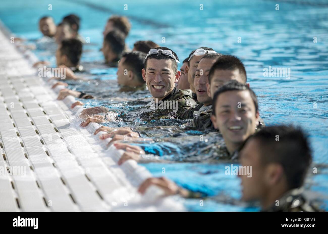 MARINE CORPS BASE CAMP PENDLETON, Calif. – Japan Ground Self Defense Force soldiers participate in a Marine Corps intermediate swim qualification as part of exercise Iron Fist Jan. 16, 2018. Iron Fist brings together U.S. Marines from the 11th Marine Expeditionary Unit and Soldiers from the Japan Ground Self Defense Force, Western Army Infantry Regiment, to improve bilateral planning, communicating, and conduct combined amphibious operations. Stock Photo