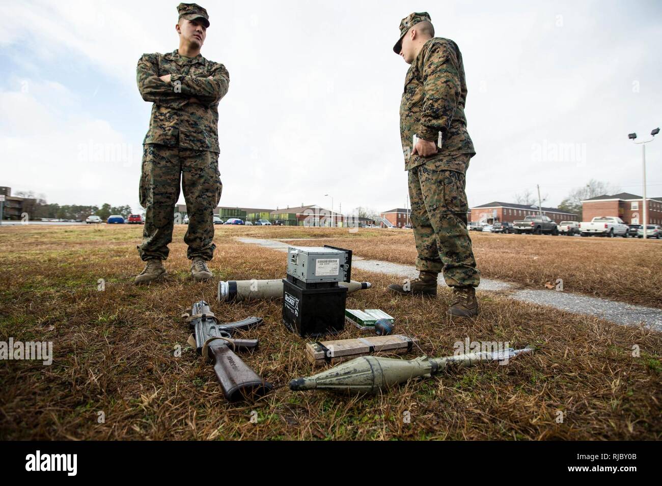 U.S. Marines with Battalion Landing Team, 2nd Battalion, 6th Marine Regiment, 26th Marine Expeditionary Unit (MEU), discuss their course of action during vehicle-borne improvised explosive device (VBIED) training on Camp Lejeune, N.C., Jan. 11, 2018. The two-day course was held to educate Marines on the proper procedures of inspecting vehicles and civilians for potential threats while also giving them the opportunity to practice techniques in preparation for the upcoming deployment. Stock Photo