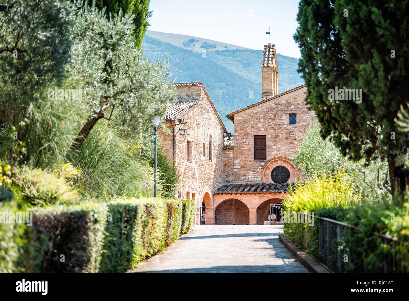 Assisi, Italy town or village city in Umbria with San Damiano church during sunny summer day and road path with nobody Stock Photo