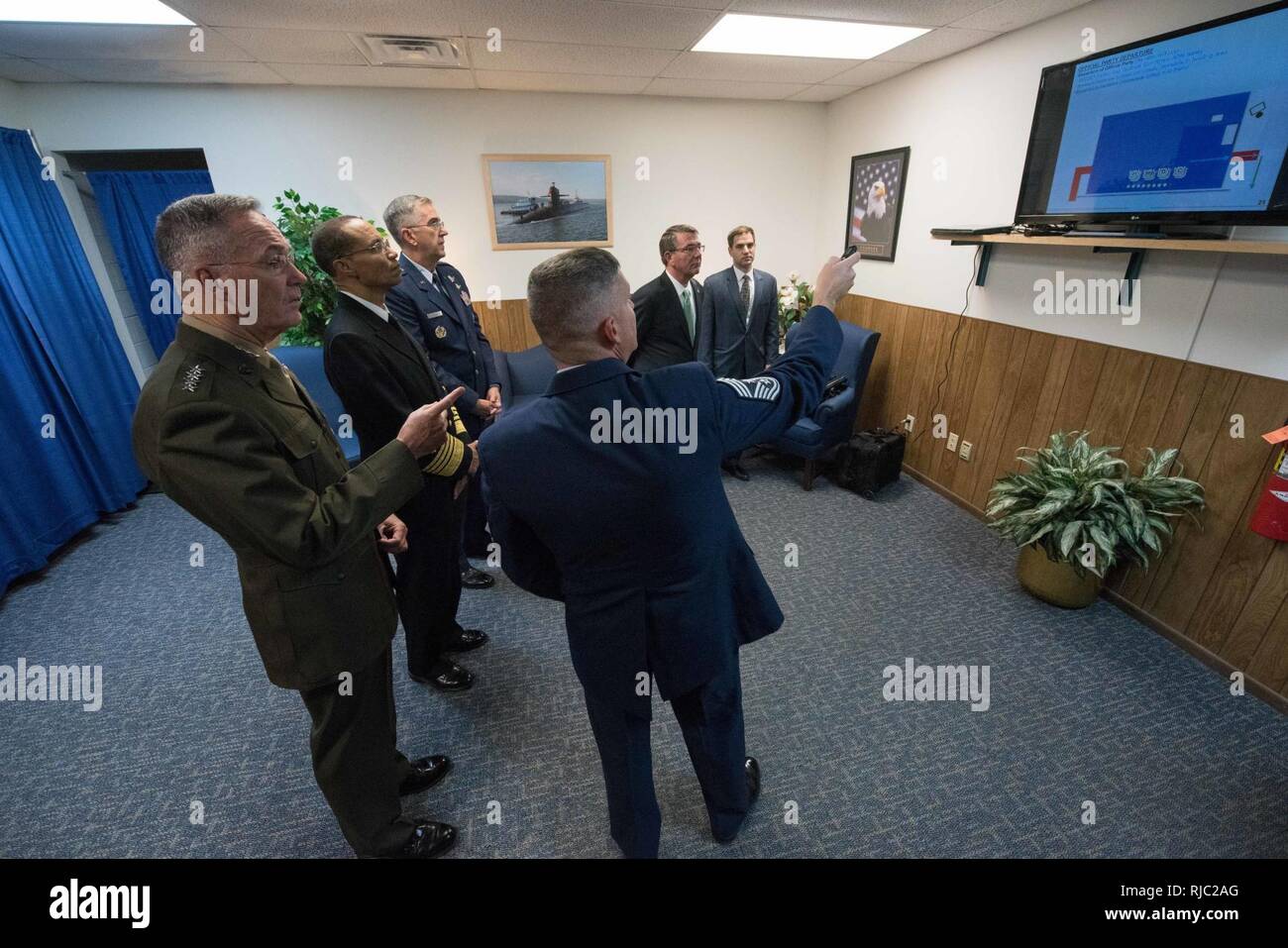 Defense Secretary Ash Carter, Marine Gen. Joseph F. Dunford Jr., chairman of the Joint Chiefs of Staff, Air Force Gen. John E. Hyten, and Navy Adm. Cecil D. Haney listen to a brief before the Strategic Command change of command ceremony at Offutt Air Force Base, Omaha, Nebraska Nov. 3, 2016.  Air Force Gen. John E. Hyten assumes command from Navy Adm. Cecil D. Haney. Stock Photo