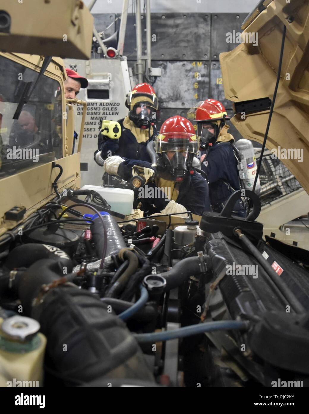 PACIFIC OCEAN (Nov 1, 2016) A firefighting team simulates fighting an engine fire in a vehicle aboard the amphibious transport dock ship USS Somerset (LPD 25). Somerset, part of the Makin Island Amphibious Ready Group, is operating in the U.S. 7th Fleet area of operations, with the embarked 11th Marine Expeditionary Unit, in support of security and stability in the Indo-Asia-Pacific region. Stock Photo