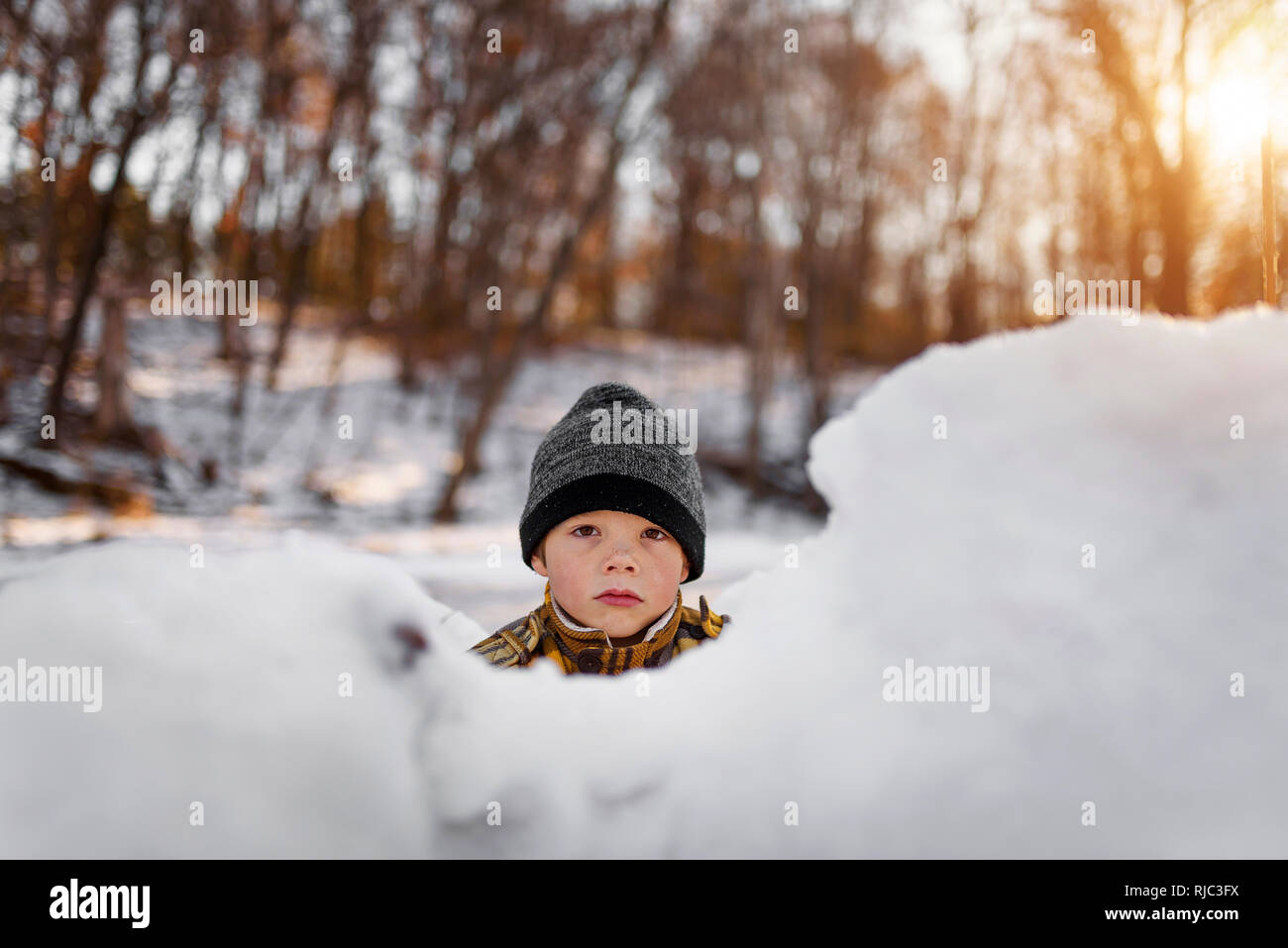 Portrait of a boy standing in a snow fort, United States Stock Photo