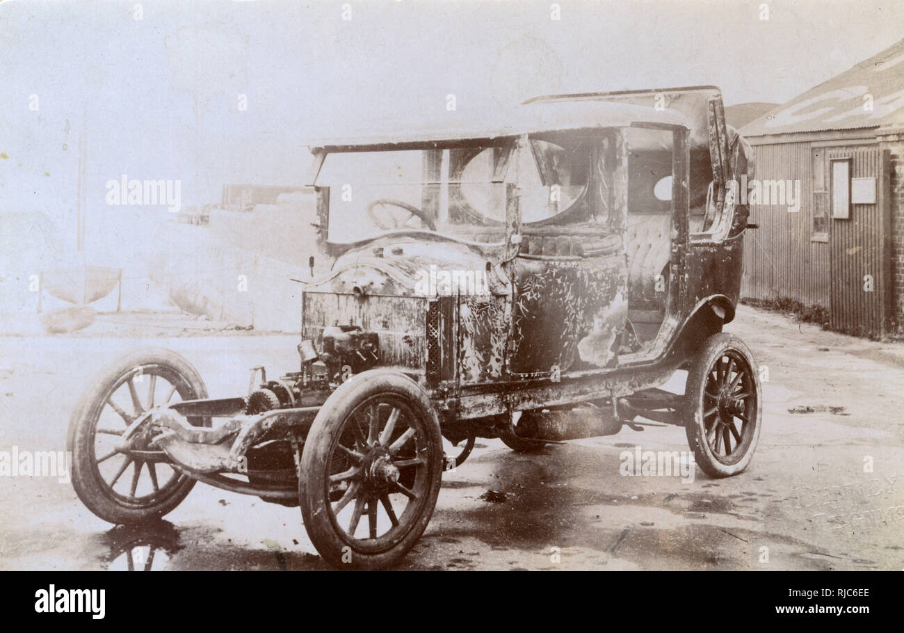 Burnt-out shell of an early motor car, possibly photographed after an accident? Stock Photo