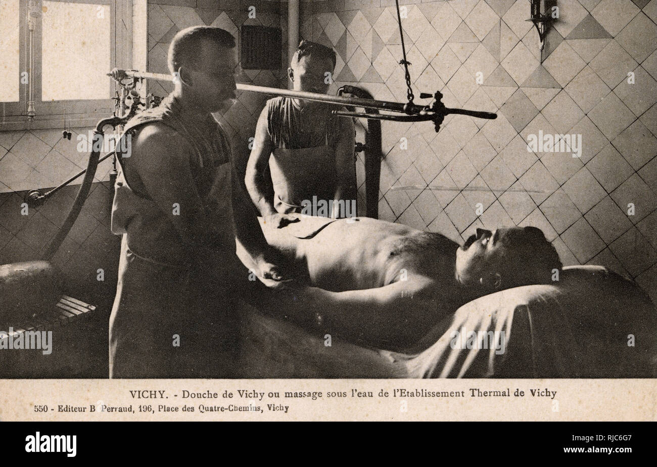 Vichy, France - Thermal Baths - Water Massage. The male attendant in the foreground appears to be checking his patient's pulse - one hopes the water jets did not have an adverse effect... Stock Photo