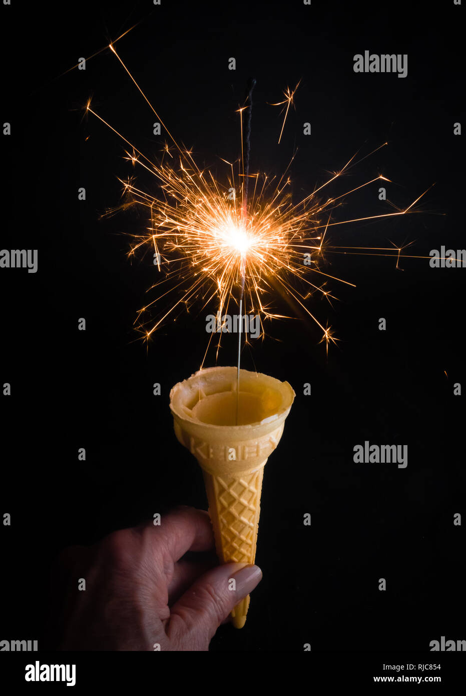 Empty Ice Cream Cone with Sparkler Stock Photo