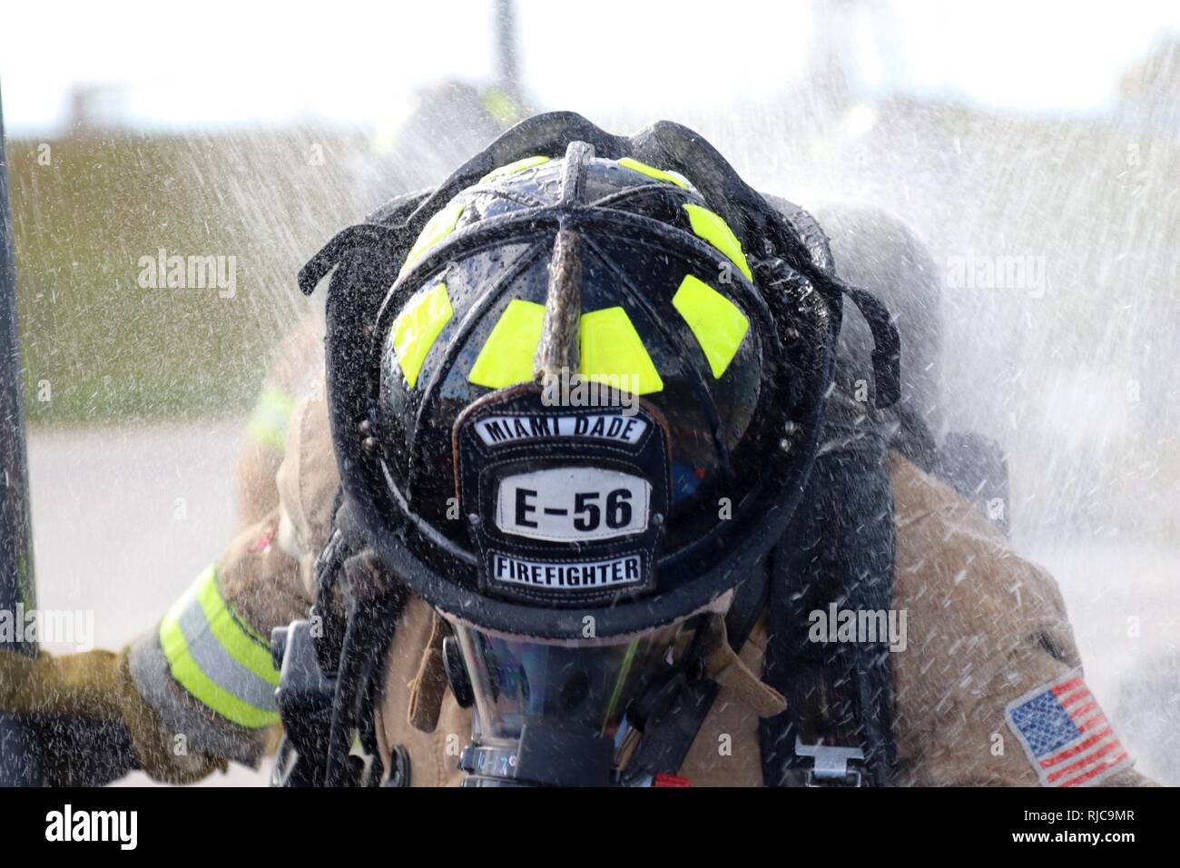 Ramon Veloso of the Miami-Dade Fire Department Hazmat team walks through the decontamination shower during a Joint Training Exercise hosted by the Miami-Dade Fire Department and Homestead-Miami Speedway in Miami, Fla. Jan. 11, 2018. This JTE focused on building response capabilities and seamless the transition between the local first responders and the follow-on support provided by the National Guard and Active duty soldiers. (U. S. Army Stock Photo