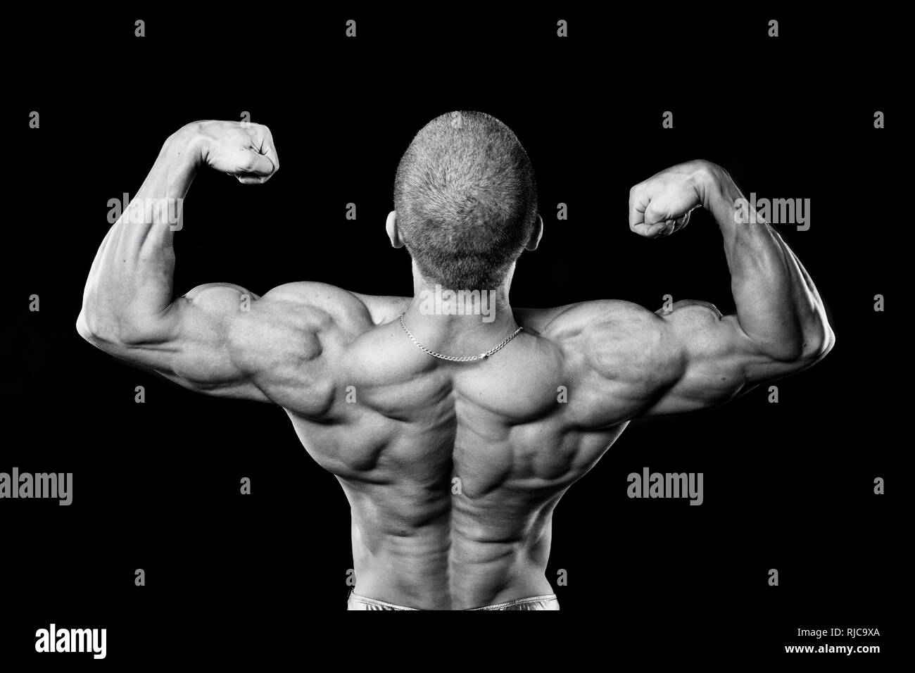 Back muscles. The athlete flexes his muscles. Bodybuilder presenting his body. Stock Photo