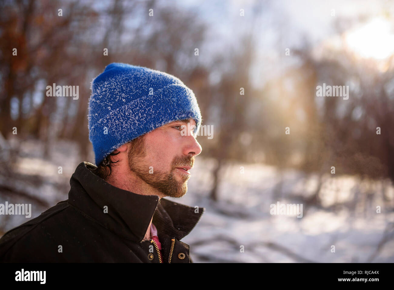 Portrait of a man standing in a winter forest, Wisconsin, United States Stock Photo