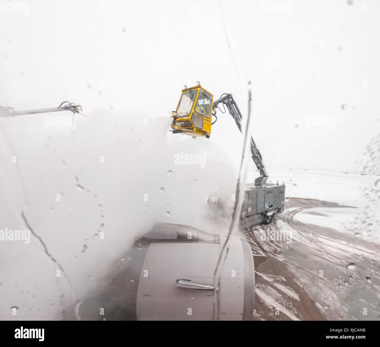 View from passenger window of de-icing of aircraft wing Stock Photo